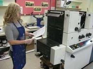 Girl at 2-color offset printing press