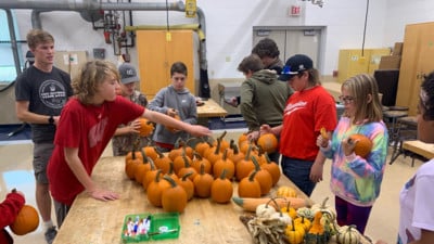 MS FFA students handle a crop of pumpkins