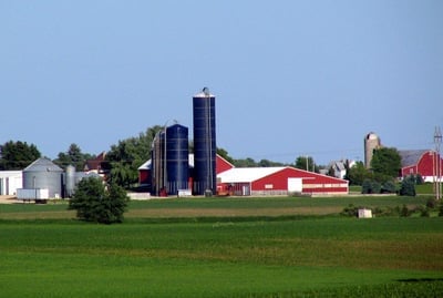 Red barn, tall silver silo and green field