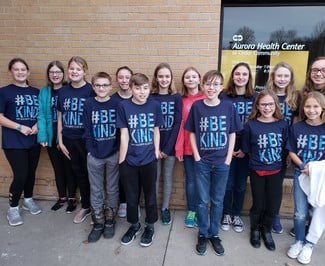 Slinger Middle School students posing with their blue Be Kind t-shirts